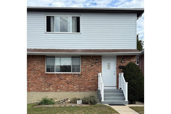 View of front of house featuring brick siding