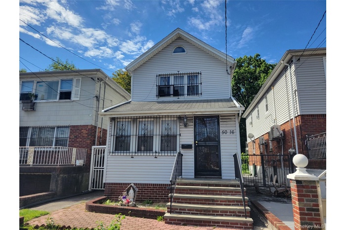 View of front of home featuring a shingled roof
