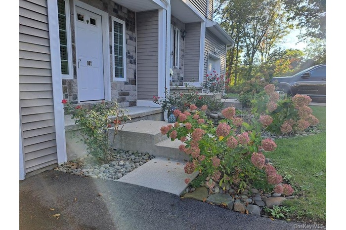 Entrance to property with stone siding and a porch