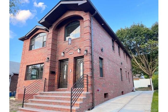 View of front facade featuring brick siding and crawl space