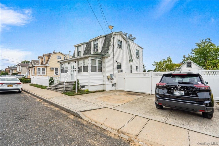 View of side of property with a gambrel roof