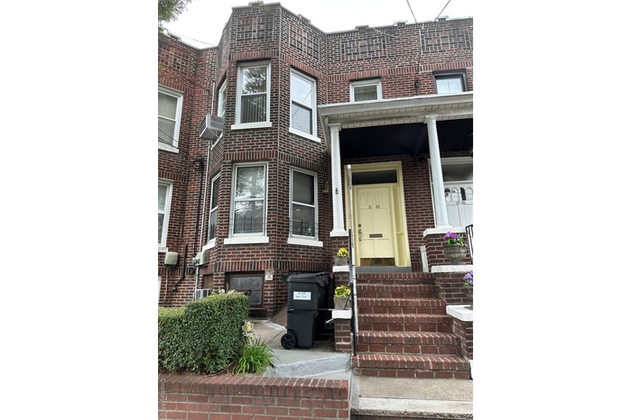 Entrance to property featuring brick siding