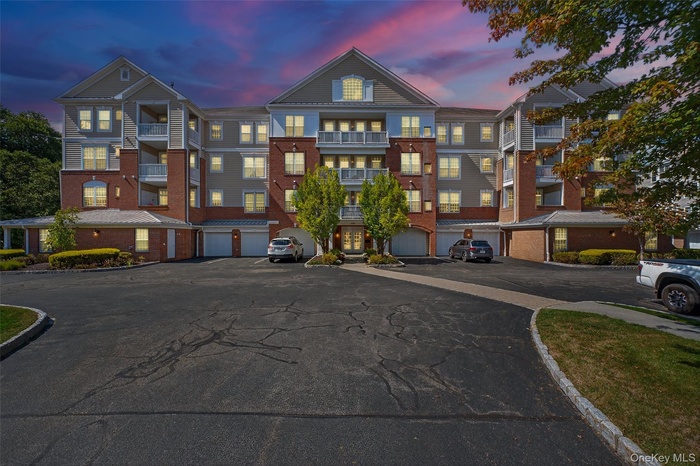 View of property at dusk