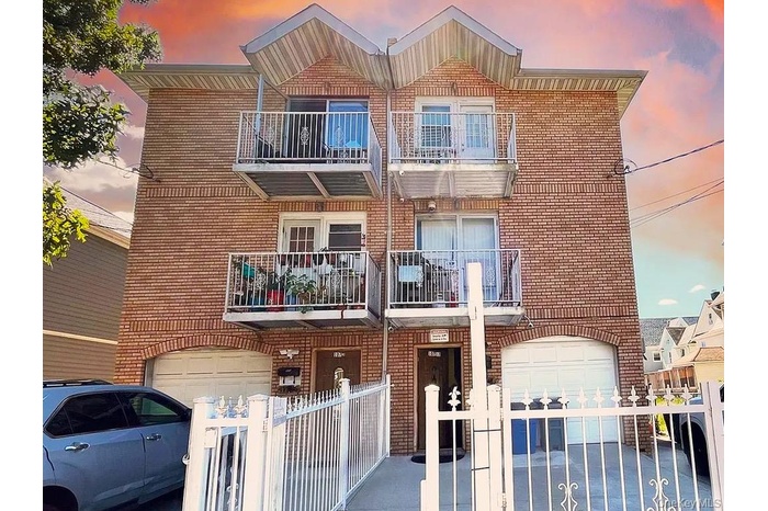 View of property with a fenced front yard and an attached garage