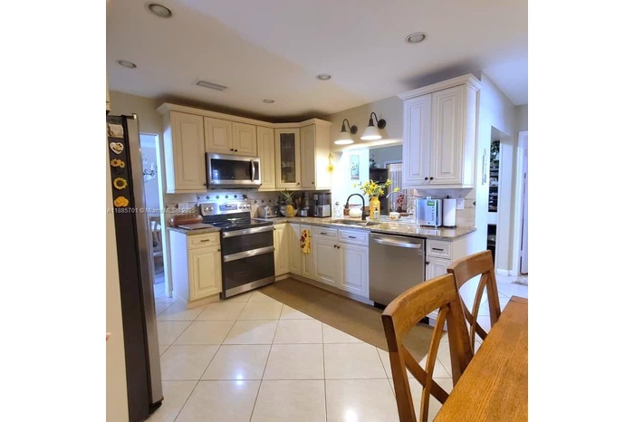 Spacious kitchen with 4 piece stainless steel appliances. Eat-in breakfast area fits large table with seating for 6 people. Also includes 3 pantries. 