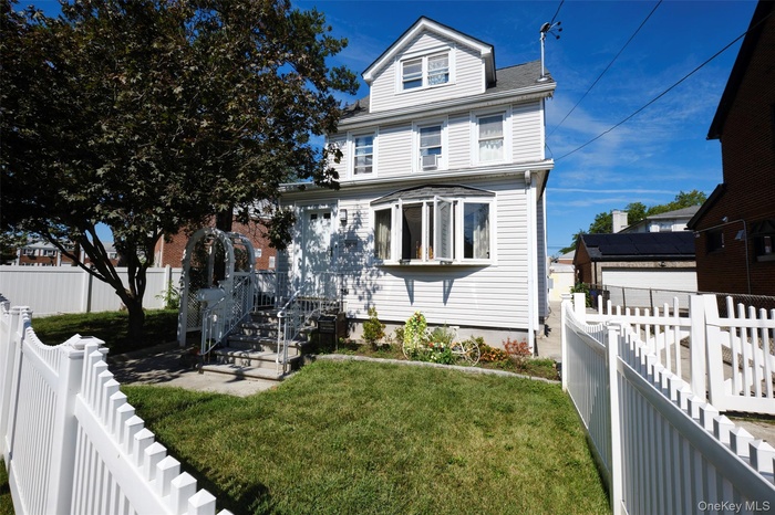 American foursquare style home featuring a fenced backyard