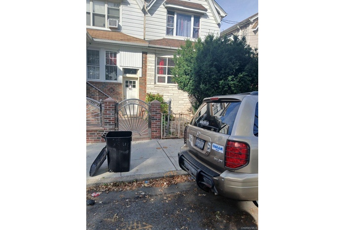 View of front of home with brick siding and a gate