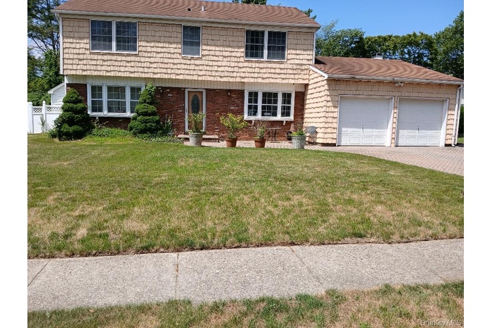 Colonial house with a garage and driveway
