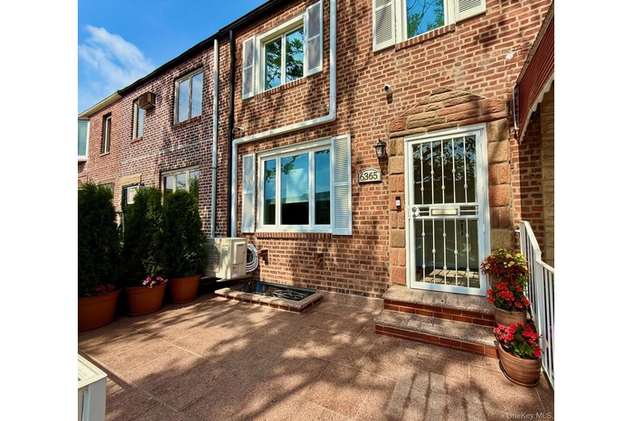 Entrance to property featuring brick siding