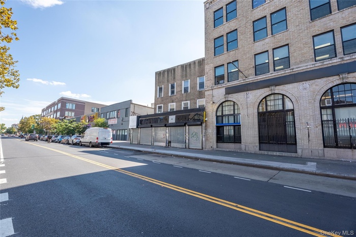 View of asphalt street featuring sidewalks and curbs