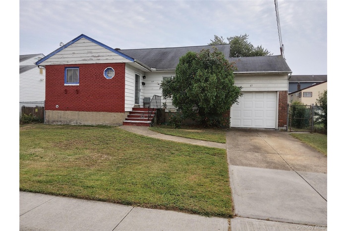 Ranch-style house featuring driveway, brick siding, a shingled roof, and an attached garage