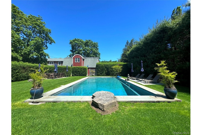 View of pool with a yard and a patio