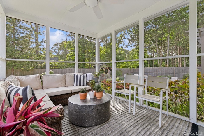 Sunroom / solarium with a ceiling fan and healthy amount of natural light