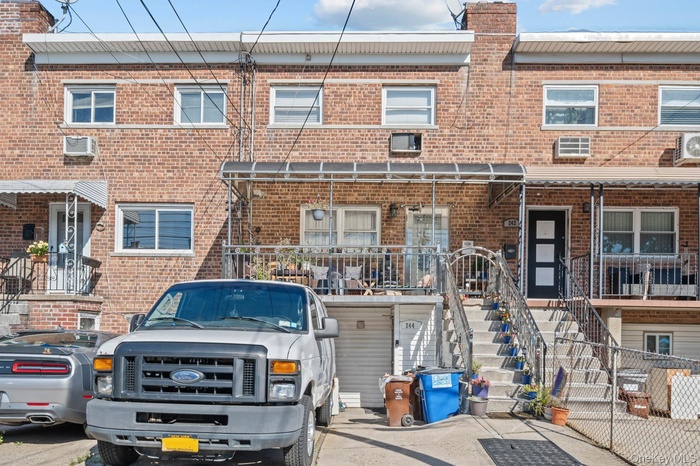 Traditional-style house with brick siding and stairway