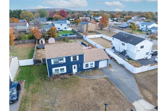Home faces East. Aerial perspective of suburban area.