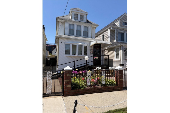 Traditional style home featuring a gate and a fenced front yard