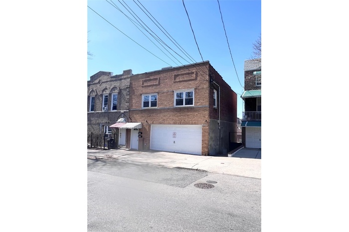 Townhome / multi-family property with brick siding and an attached garage