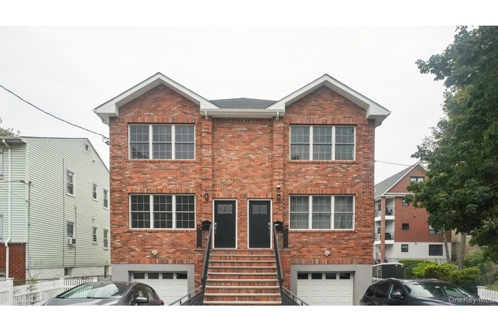Traditional-style house with brick siding and a garage