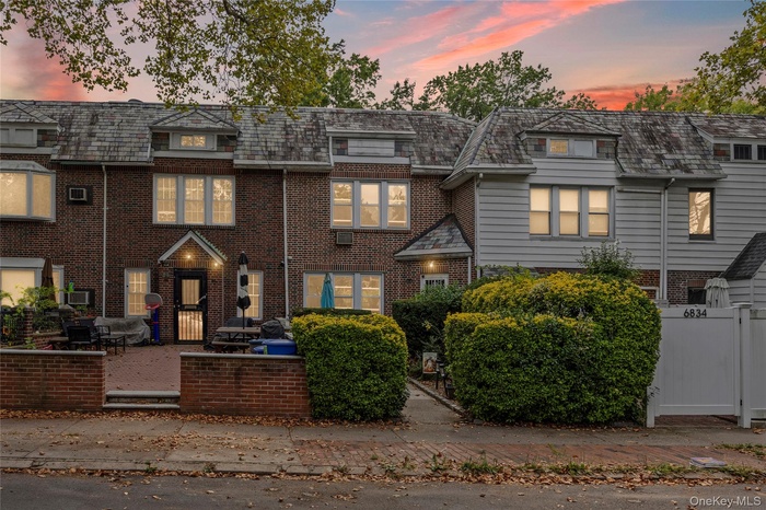 Traditional-style home featuring brick siding