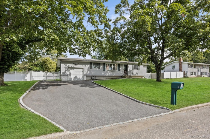Ranch-style house featuring asphalt driveway
