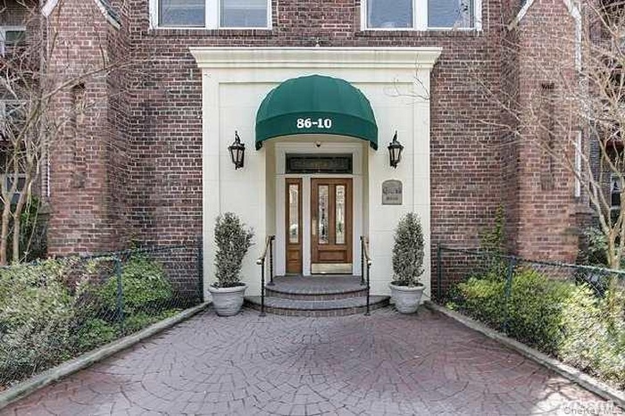 Property entrance featuring brick siding