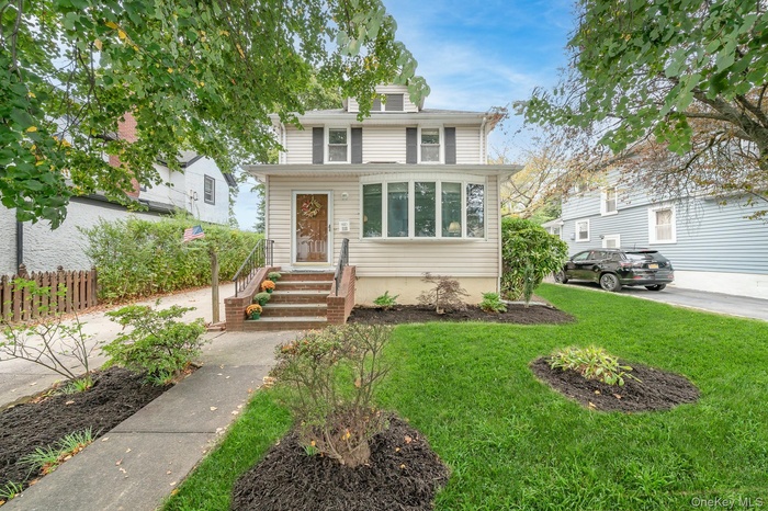 Traditional style home with a front lawn and a chimney