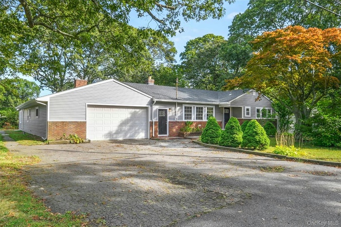 Ranch-style house with brick siding, and attached garage