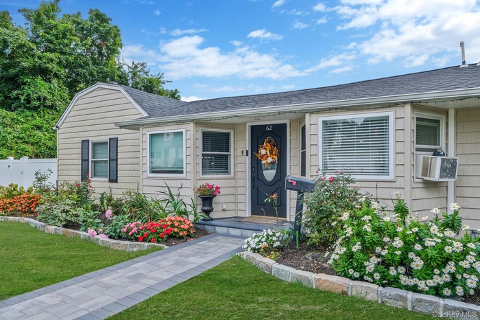 View of front of house with a shingled roof