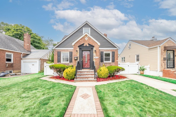 Bungalow-style home featuring a gate and brick siding