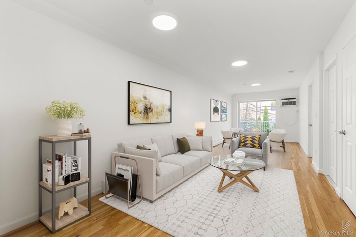 Living area featuring light wood-style floors and recessed lighting