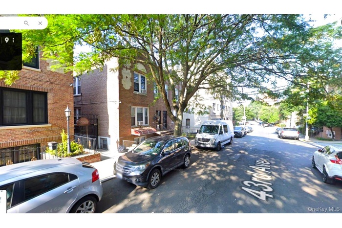 View of asphalt street featuring a residential view and sidewalks