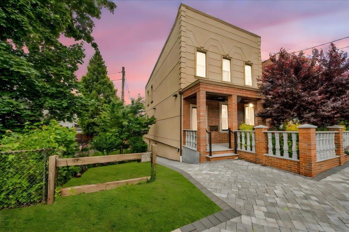 View of front of house featuring a porch and brick siding