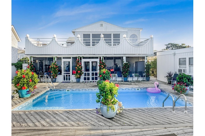 Outdoor pool featuring a patio, french doors, and a wooden deck