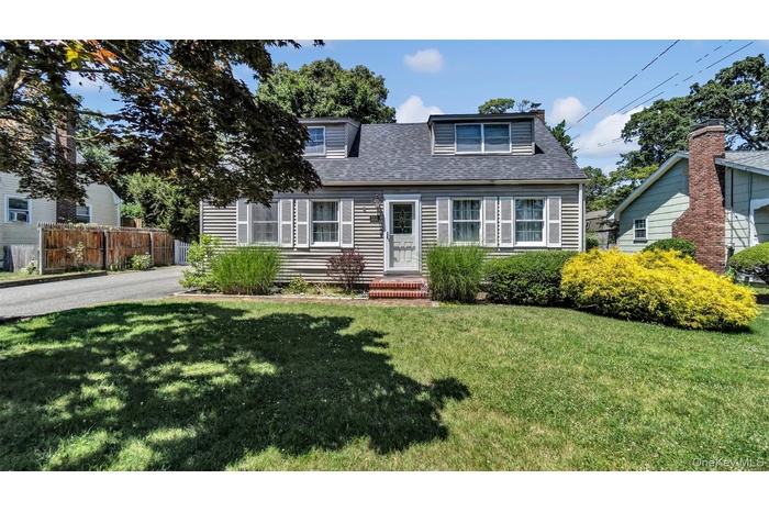 View of front of house with a shingled roof