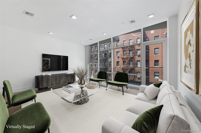 Living area with a wall of windows and wood finished floors