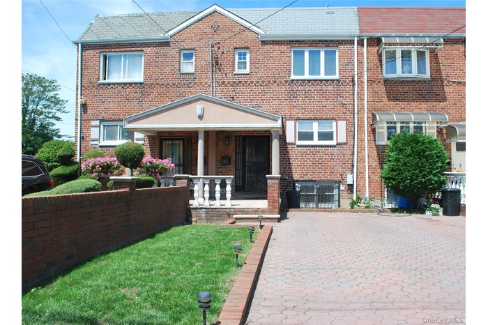 View of front of house featuring covered porch and brick siding