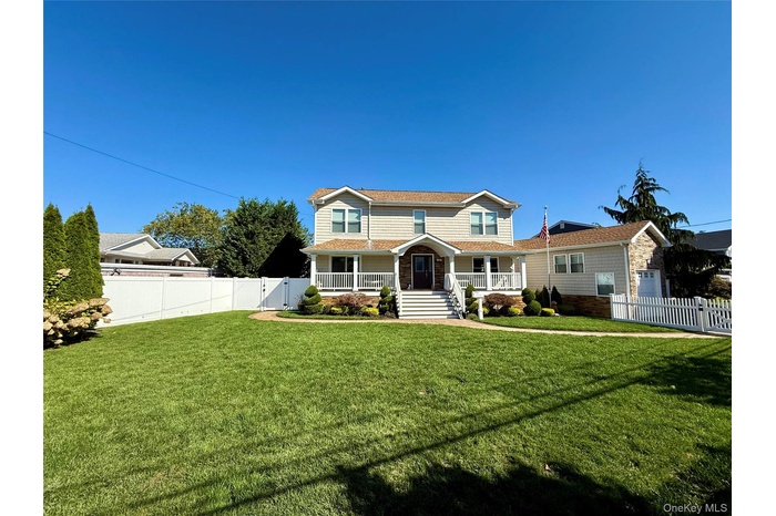 Traditional home featuring covered porch and a gate