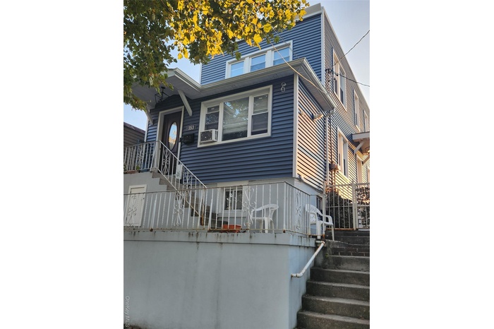 View of front facade featuring stairs
