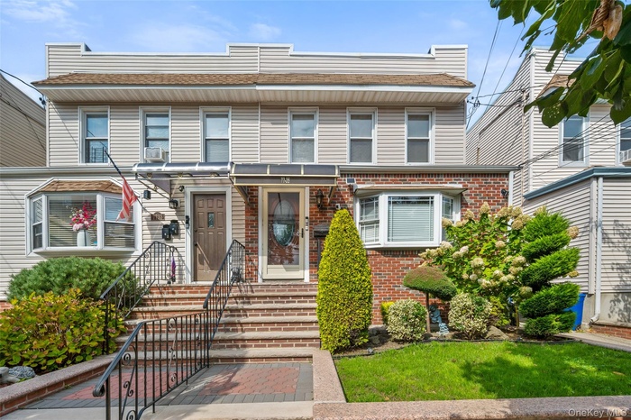 View of front of home featuring brick siding and a front lawn
