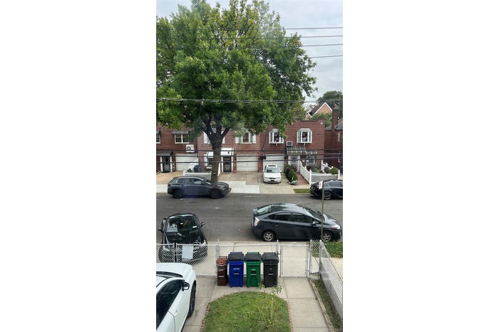 View of asphalt road with sidewalks and a gate