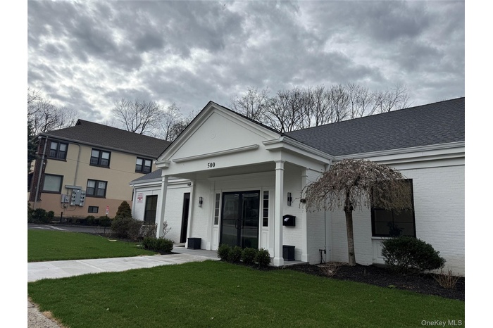 View of front of house featuring brick siding and a front lawn