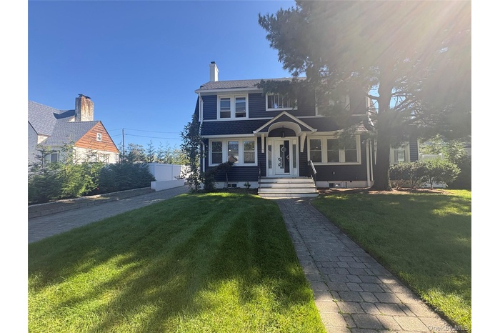 View of front facade featuring a chimney