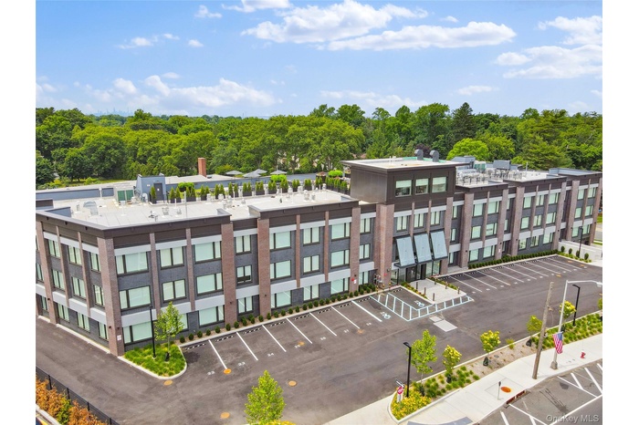 View of building exterior featuring uncovered parking