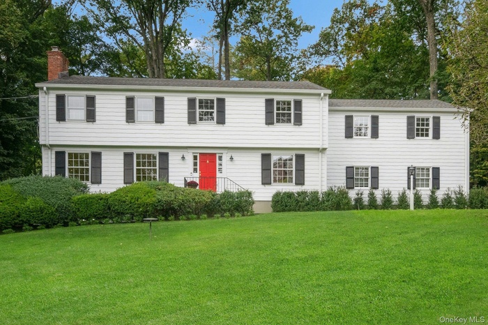 Center hall Colonial home with primary suite addition over the 2 car garage set far back on 1.38 private acres