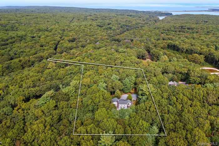 Aerial view of property's location featuring property parcel outlined and a large body of water