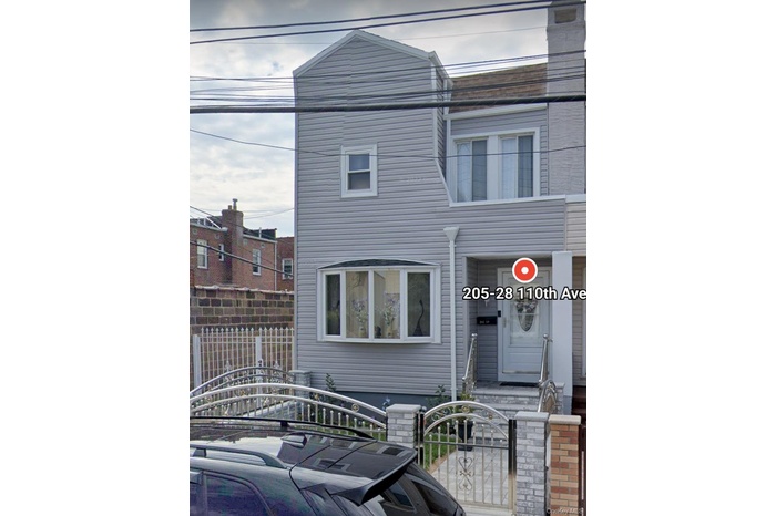 Townhome / multi-family property featuring a fenced front yard and a gate