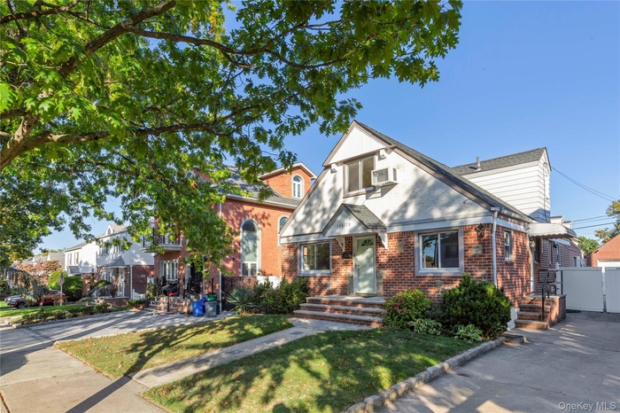 View of front of house featuring brick siding and a front yard