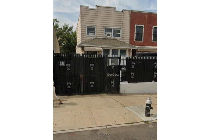 View of gate with a fenced front yard