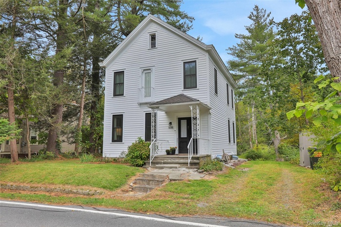 View of front of property with a front lawn