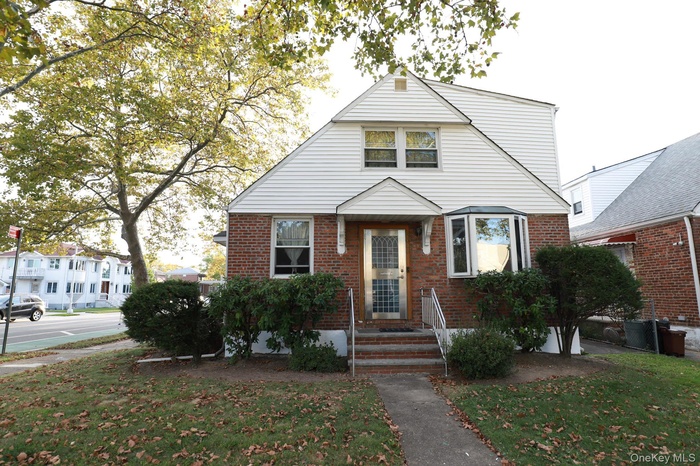 Bungalow-style house featuring a front yard and brick siding